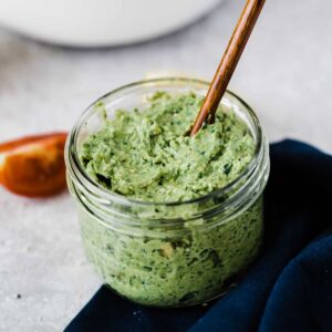 vegan avocado and basil pesto in mason jar with spoon