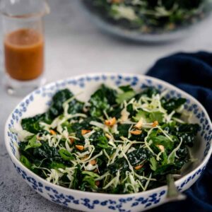 crunchy kale salad with spicy peanut vinaigrett in a serving bowl