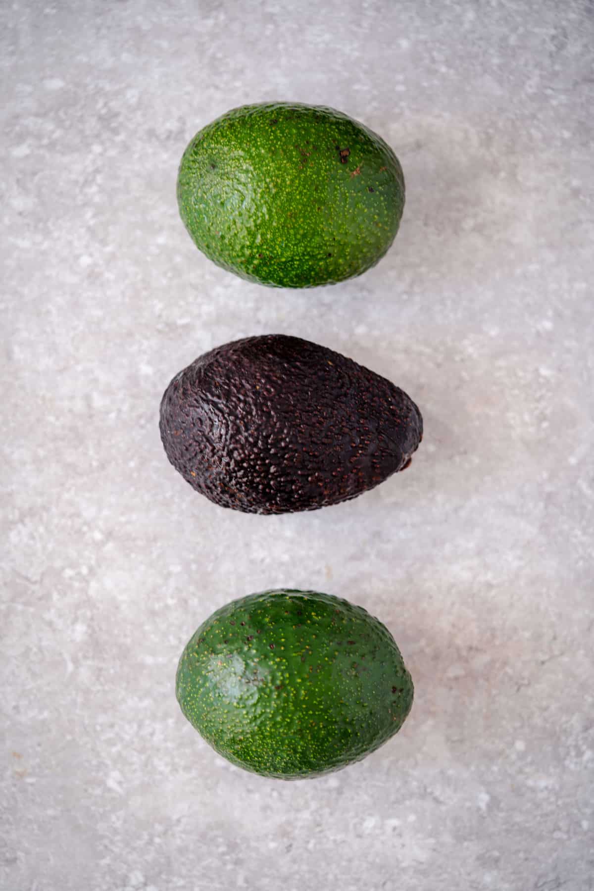 three avocados lined up 