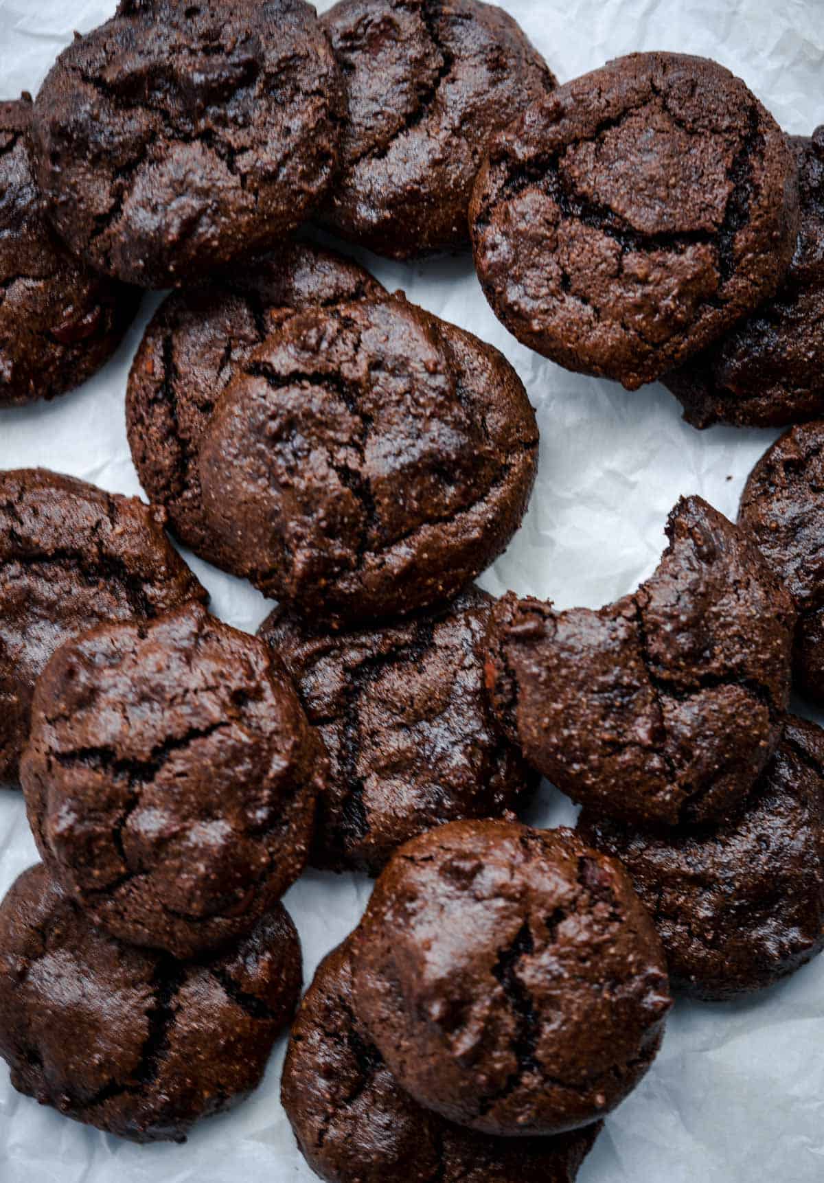 Chocolate fudge tahini cookies piled