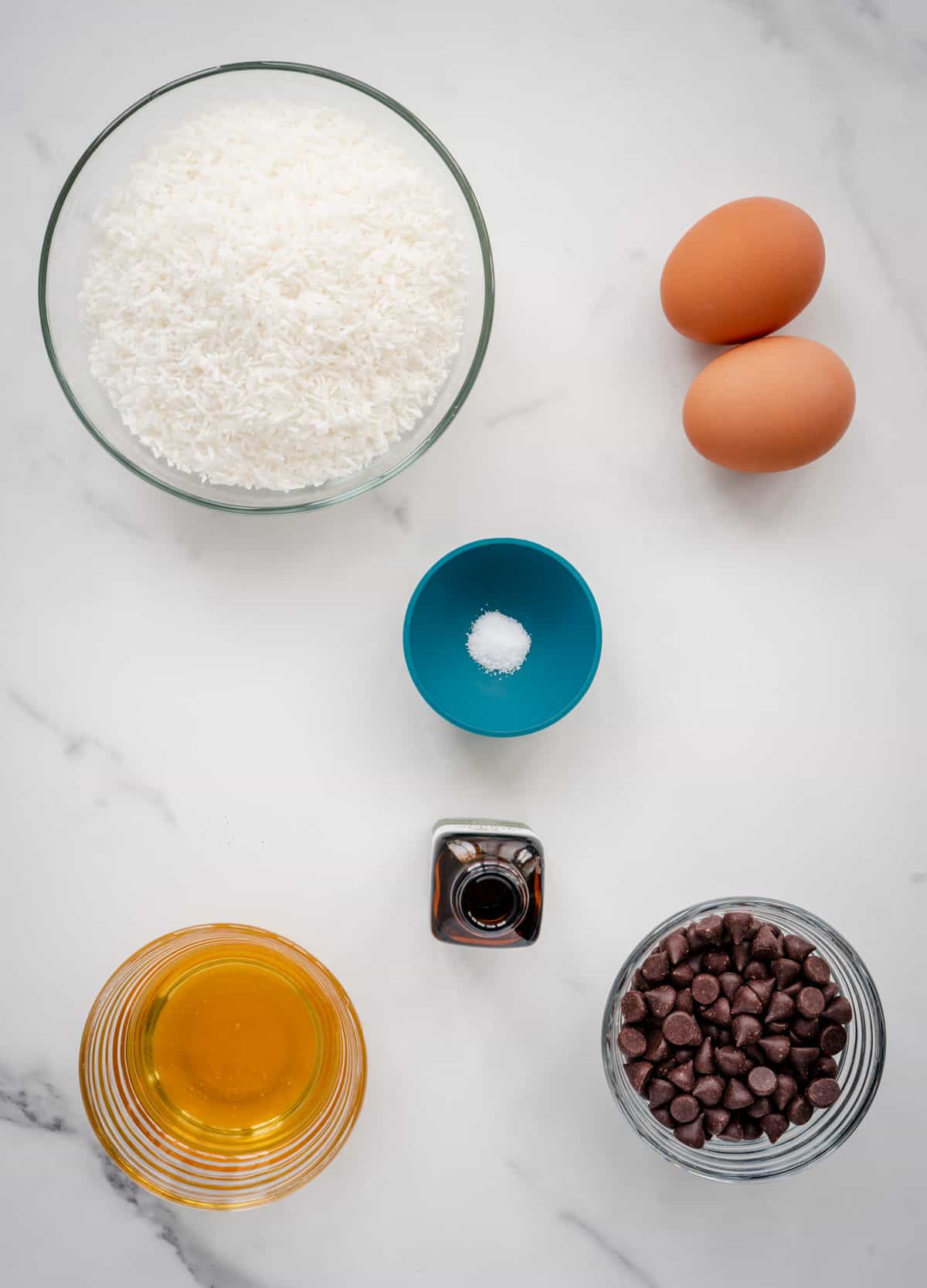 Ingredients for Chocolate-dipped peppermint coconut macaroons, coconut, salt, eggs, peppermint extract, honey, dark chocolate