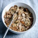 dairy free mushroom sauce in white bowl with spoon.