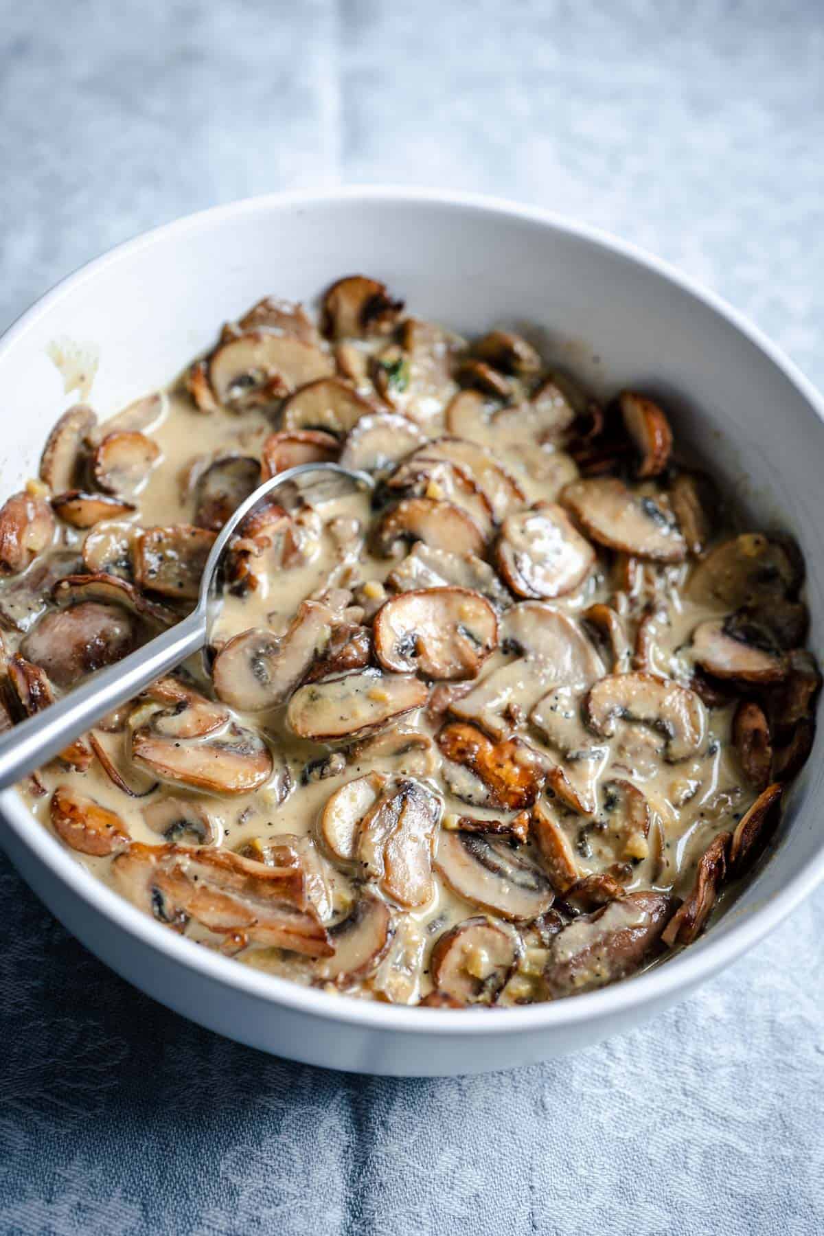 easy creamy mushroom sauce without dairy in white bowl with spoon