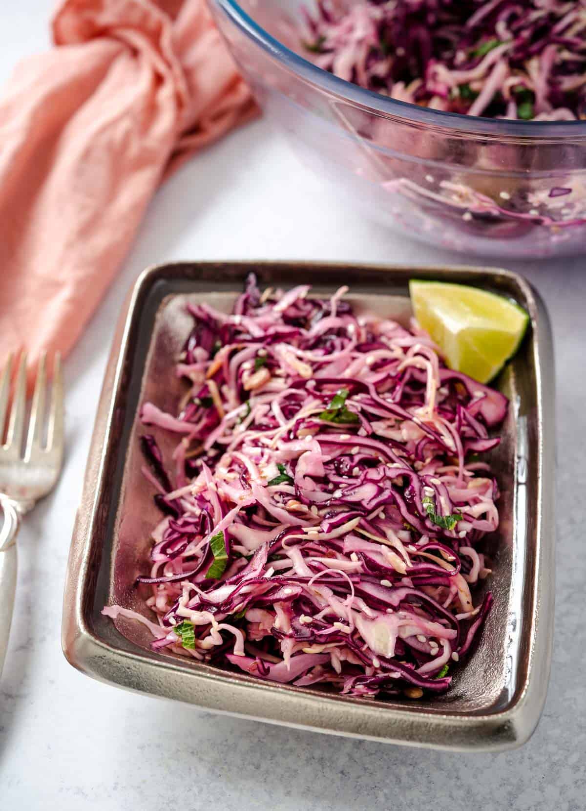 crunch cabbage salad with lemon wedge in dish