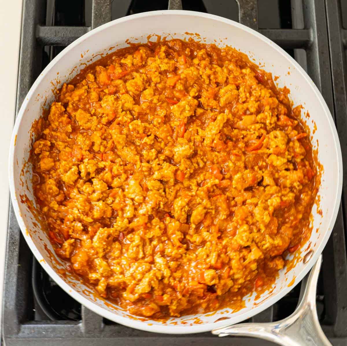 homemade sloppy joes process shot in pan with tomato sauce.