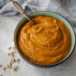 close up of romesco sauce nut free in bowl with serve spoon.