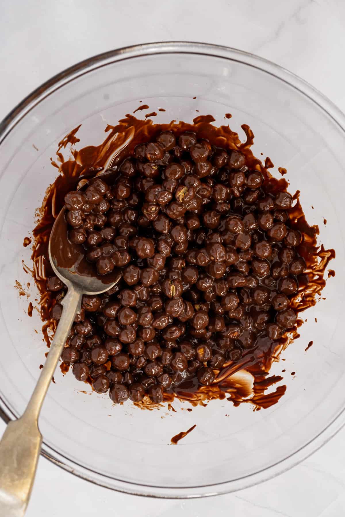 combined roasted chickpeas and melted chocolate in large bowl with large spoon.