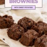 6 sweet potato brownies lined up on parchment. Pin image.