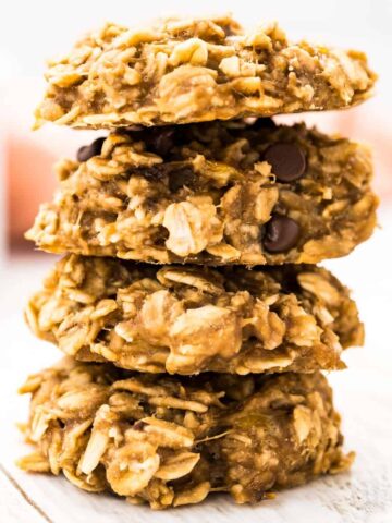 Four banana oatmeal breakfast cookies piled on top of each other.