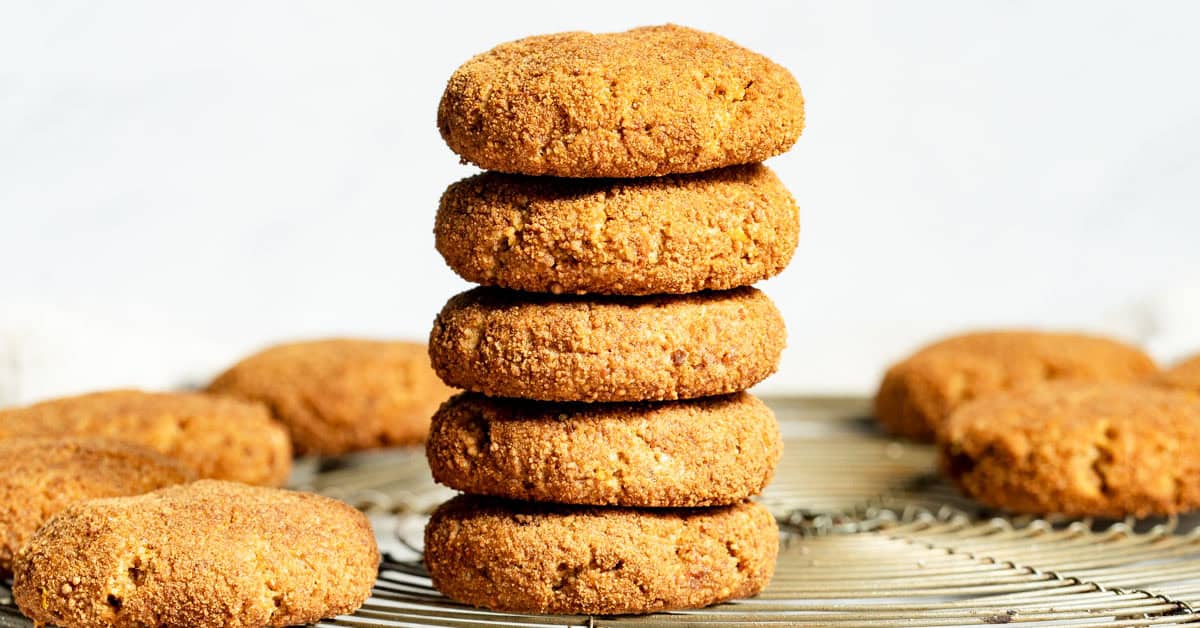Five sweet potato cookies stacked on round cooling rack.