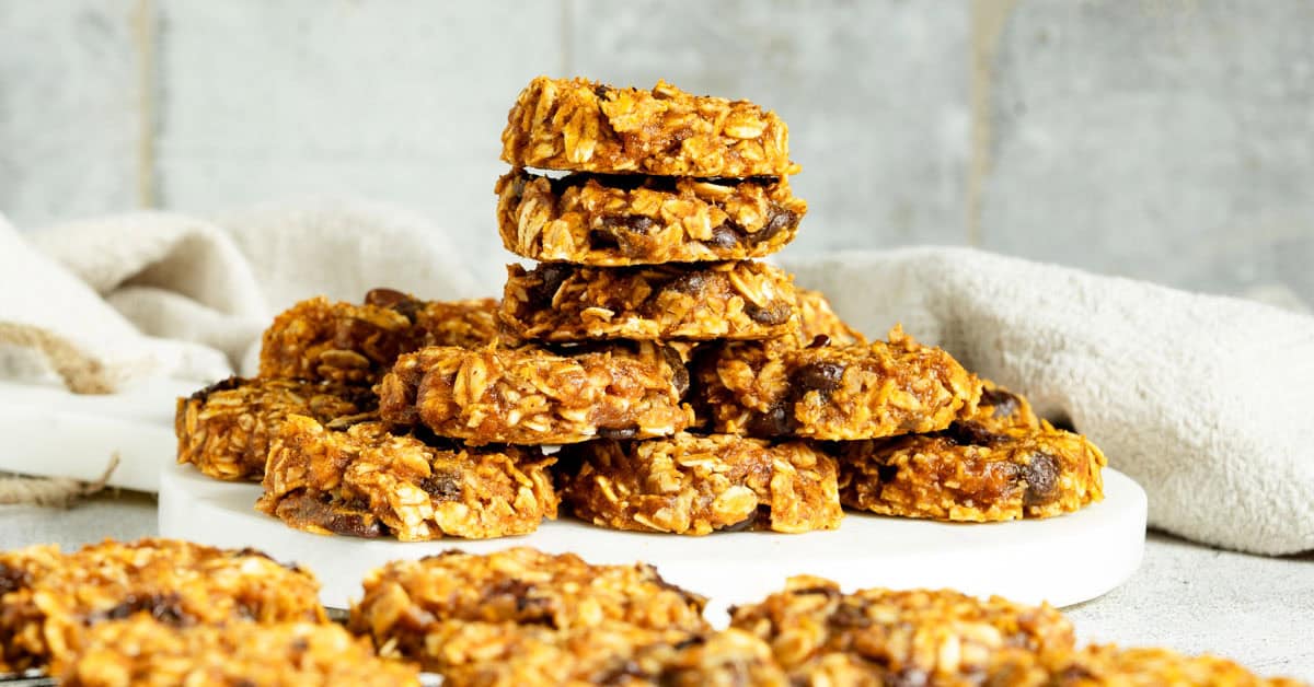 Sweet potato oatmeal cookies stacked with beige napkin in background.