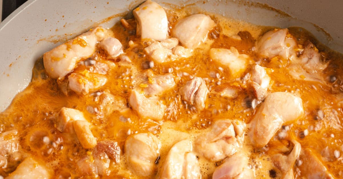 Teriyaki chicken cooking in a pan.